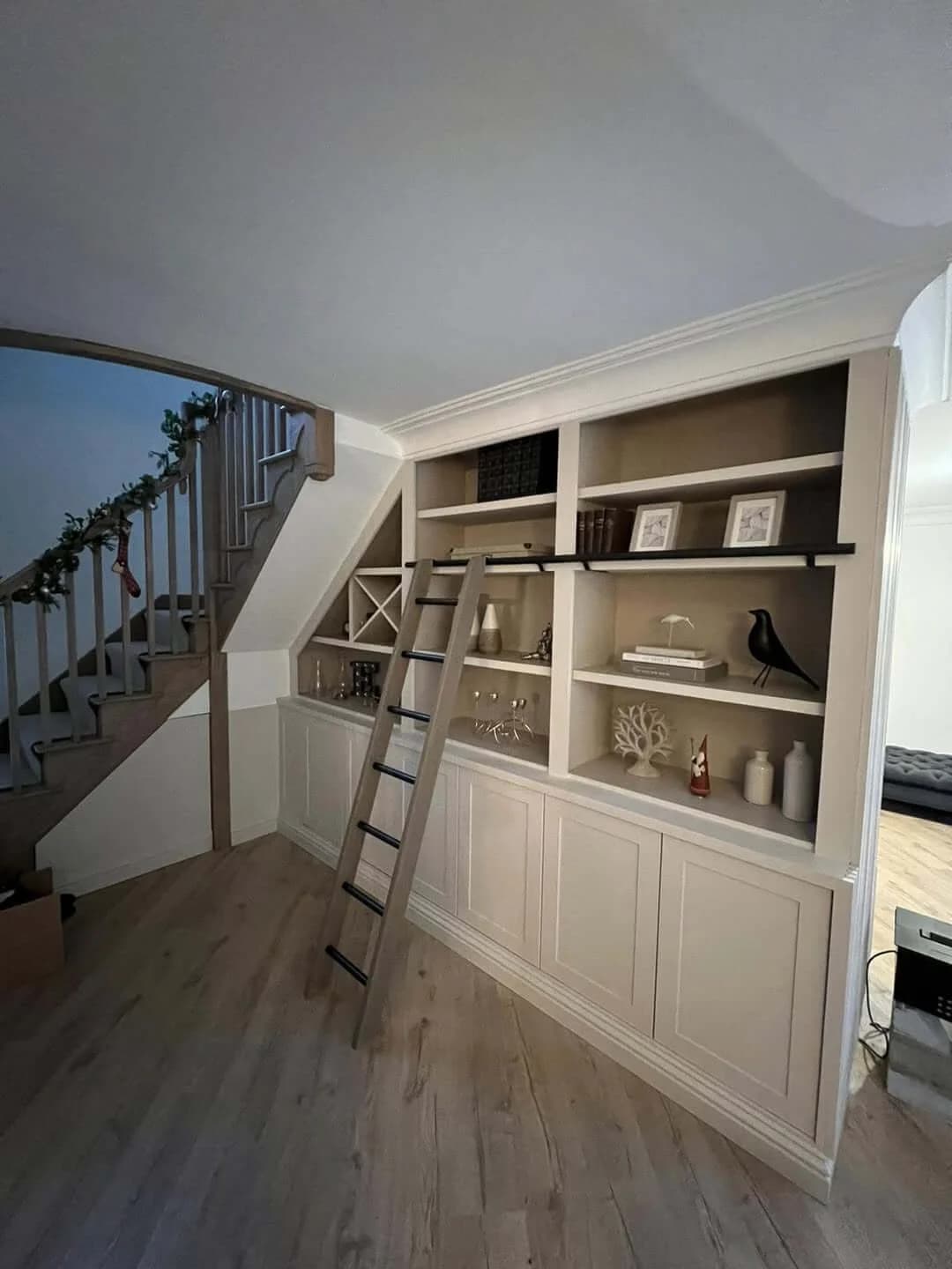 Alcove shelving beside a spiral staircase